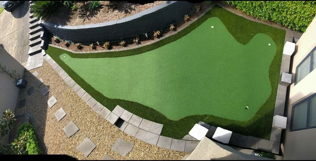 An aerial view of a golf course in a backyard