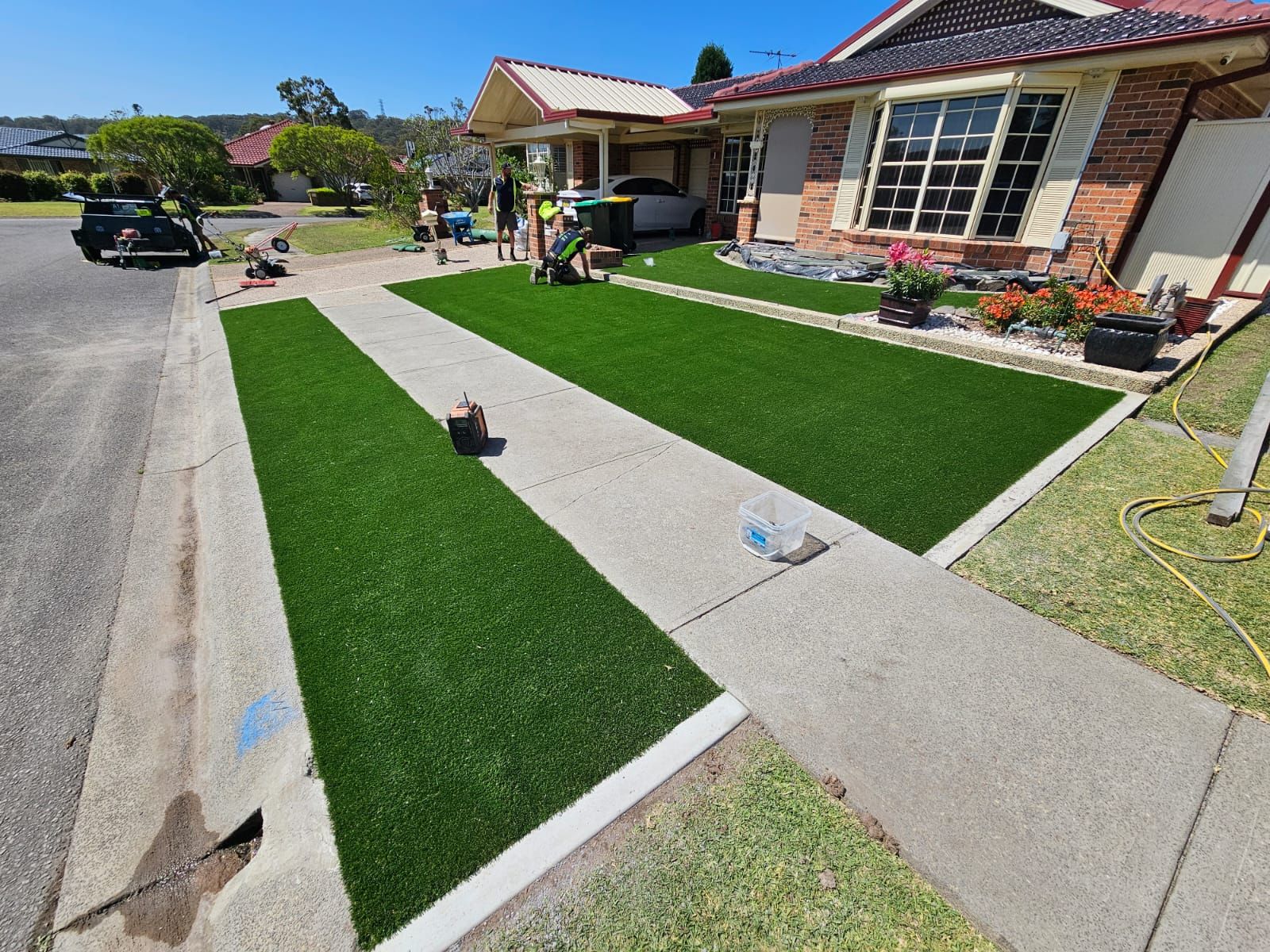 A lawn is being installed in front of a house.