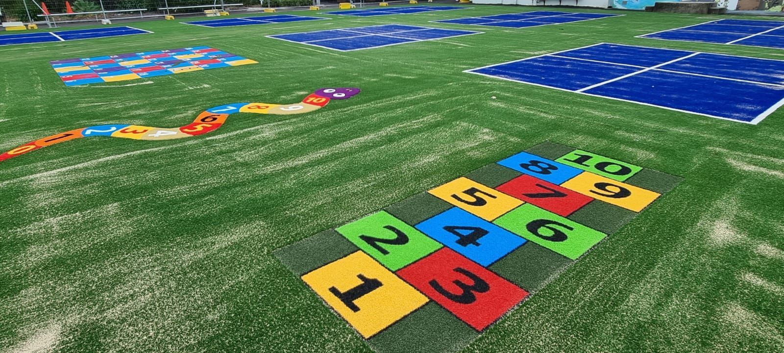A field with a hopscotch game painted on it.