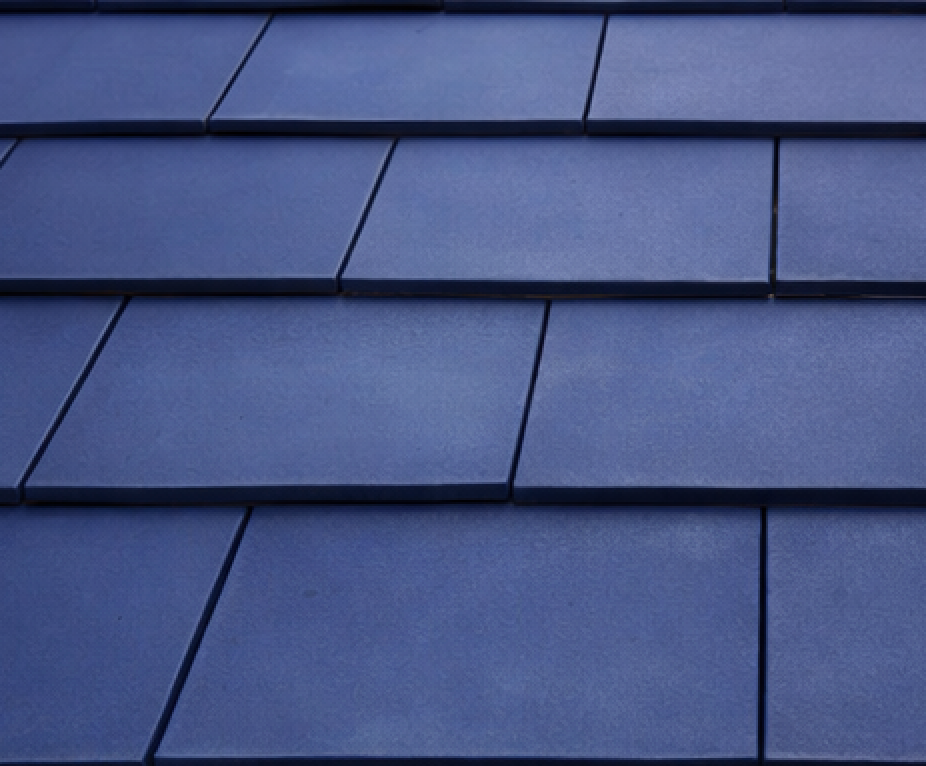 Dark blue rectangular roof tiles arranged in rows.