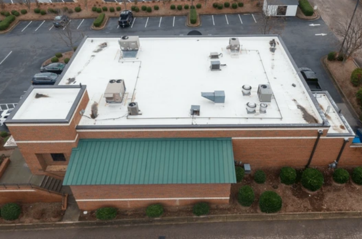 large commercial building with white flat roof