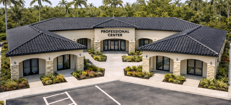 Professional center with black tile roof and beige walls, surrounded by trees and a parking lot.