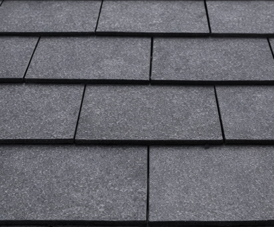 Close-up of gray asphalt roof shingles, textured and overlapping.