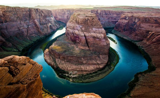 A river in the middle of a canyon surrounded by rocks