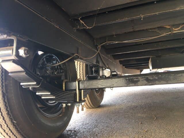 Black Trailer Undercarriage With Tires — Andy's Caravan Repairs in Harristown, QLD
