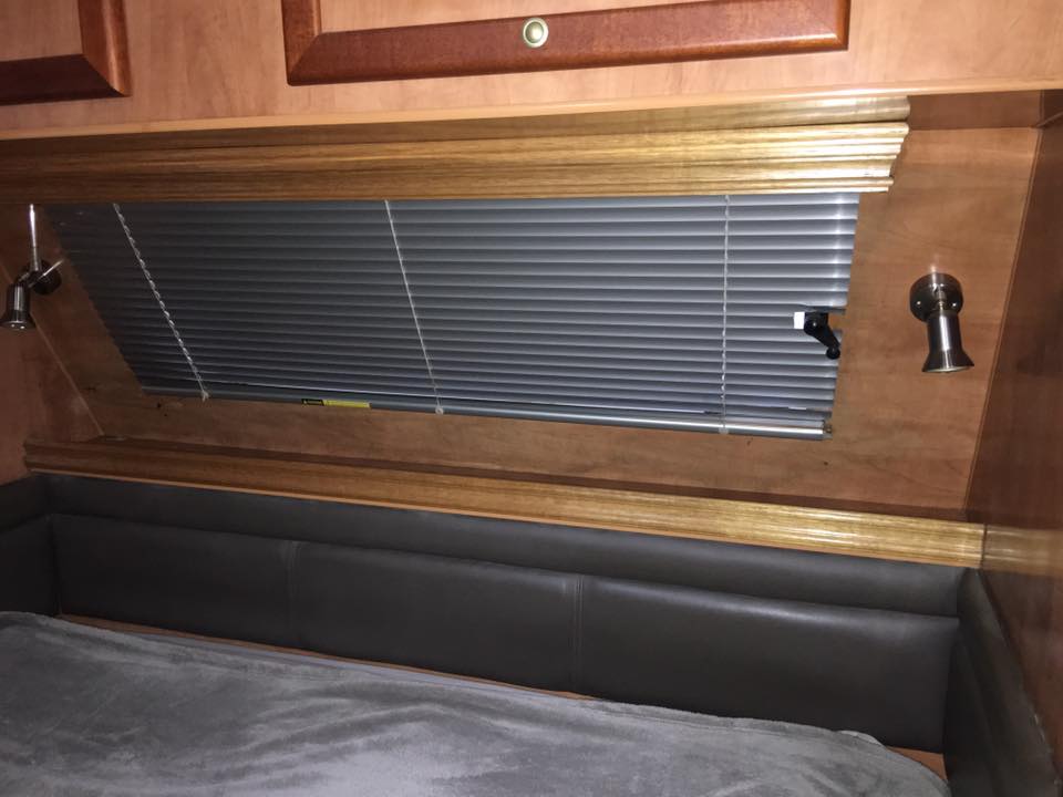 Bedroom With Bed, Blinds, Sconces, and Wood Trim — Andy's Caravan Repairs in Harristown, QLD