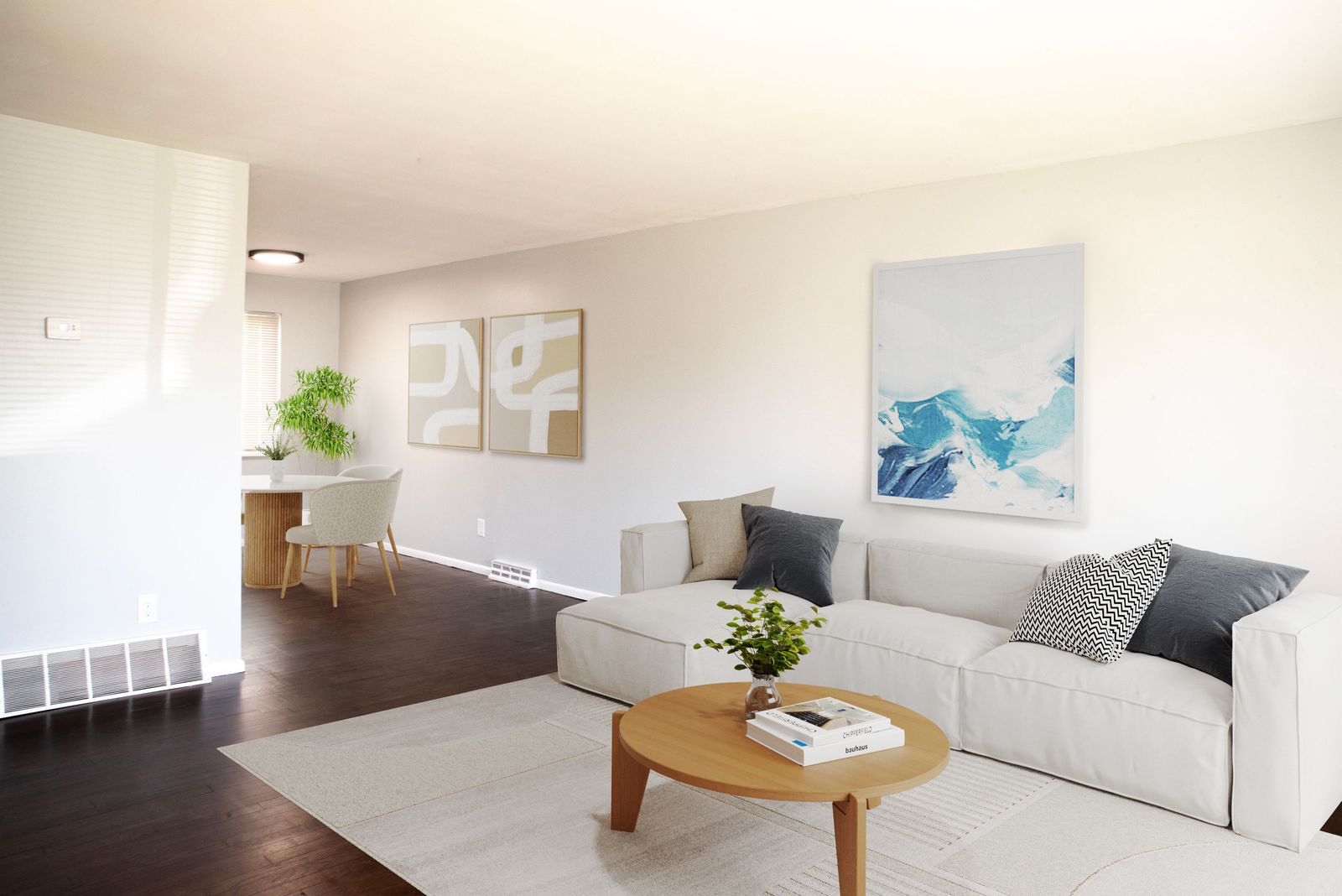 A living room with a white couch and a wooden coffee table
