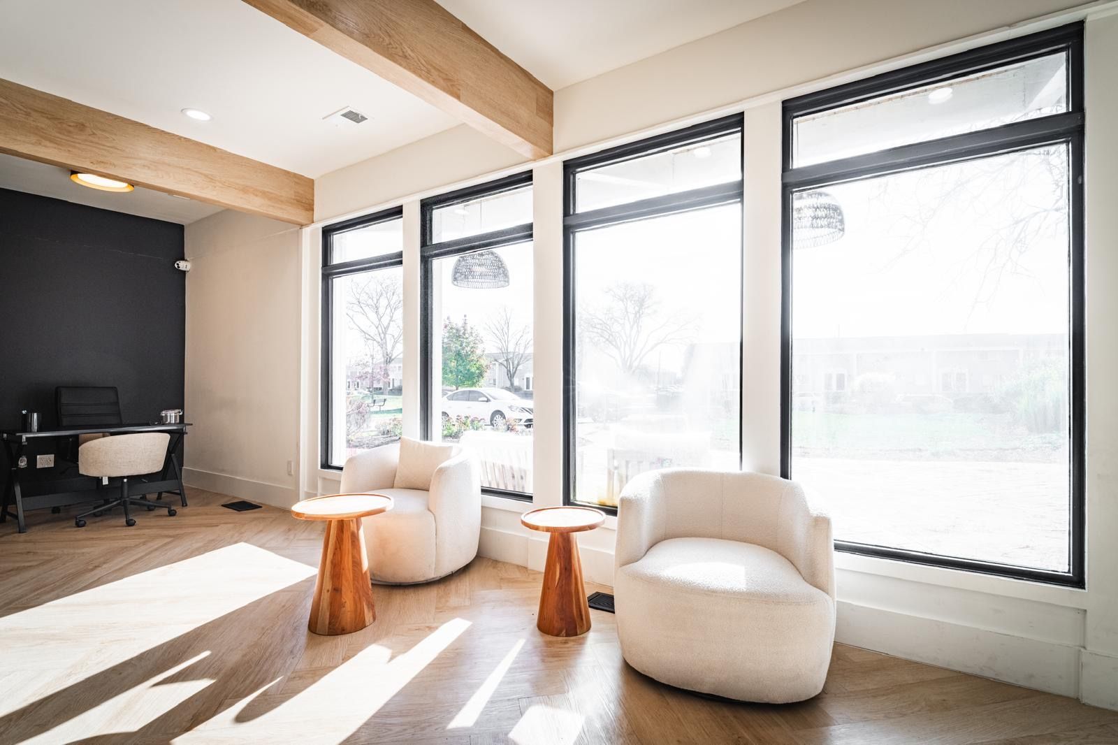 There are two chairs and two tables in the room.