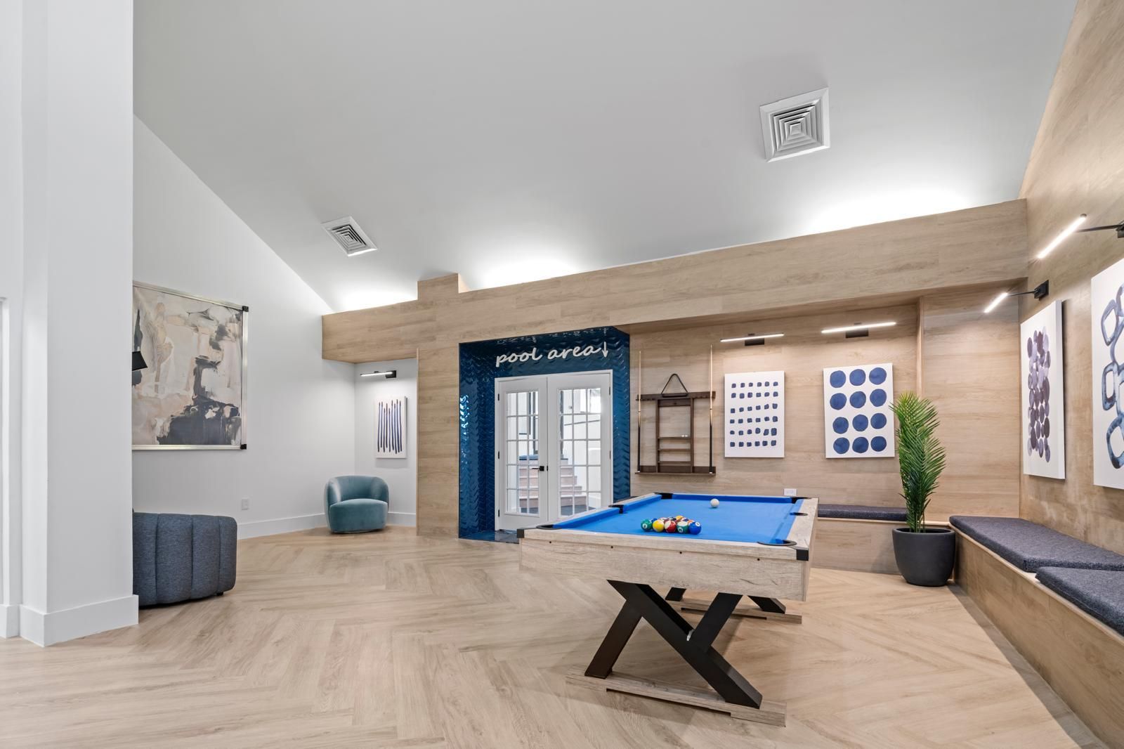 There is a pool table in the middle of the room.