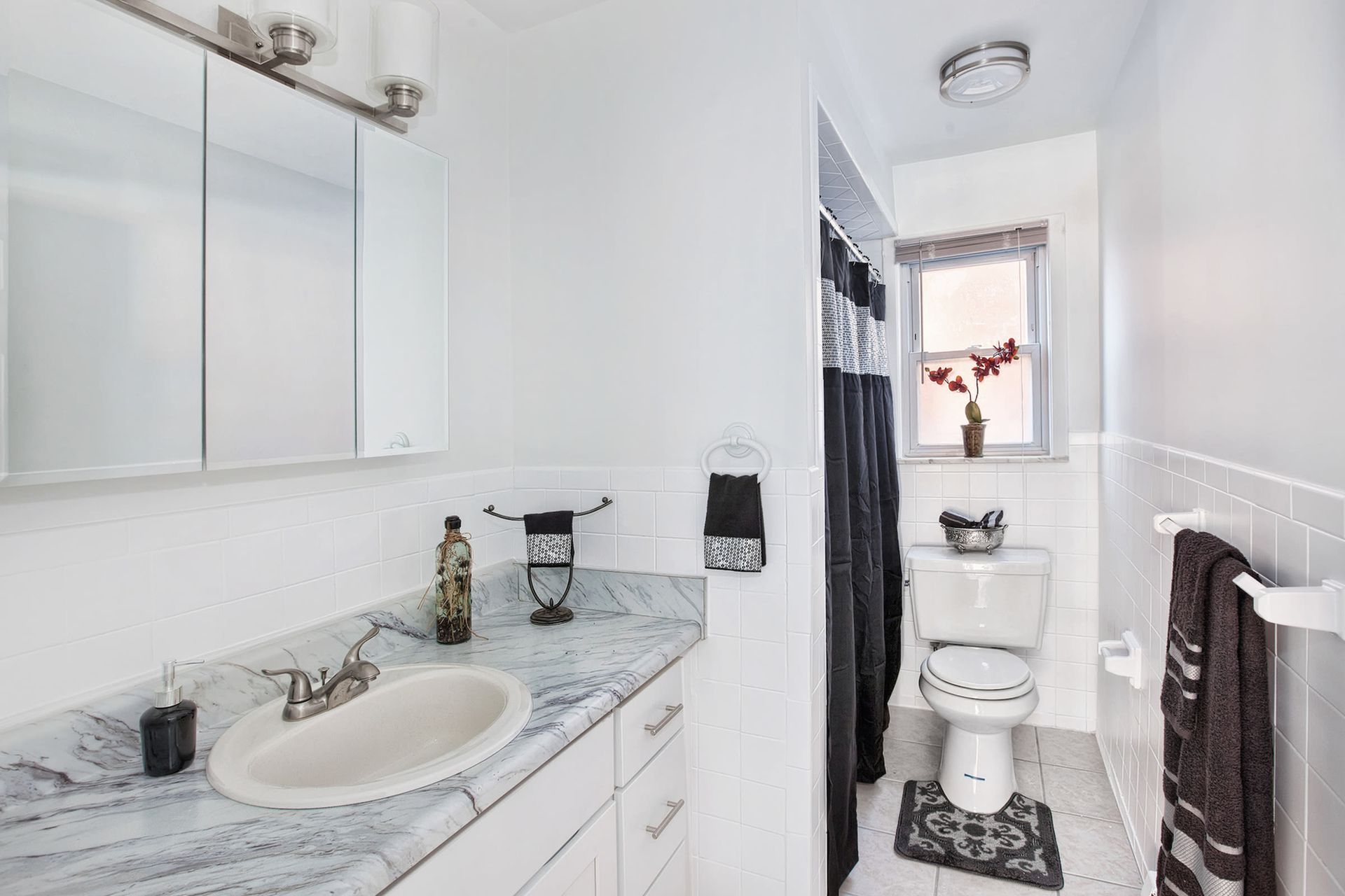 Bright apartment bathroom with marble vanity, mirror, and toilet. 
Ready to make Joralemon your home? Contact us today to learn more about our pet-friendly 1, 2, and 3-bedroom apartments for rent in Belleville, NJ. We can’t wait to welcome you home!