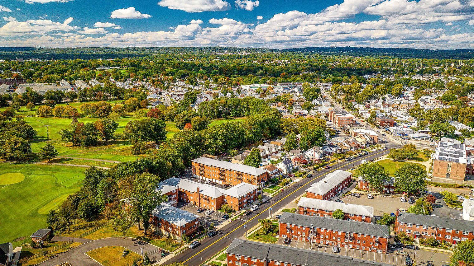 Aerial view of a multifamily apartment complex along a street beside a large green park. Ready to make Joralemon your home? Contact us today to learn more about our pet-friendly 1, 2, and 3-bedroom apartments for rent in Belleville, NJ. We can’t wait to welcome you home!