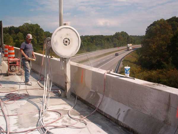 Worker Checking Hose — Knoxville, Tennessee — True-Line Coring & Cutting