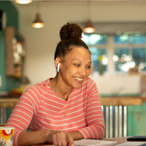 A woman is talking on a computer, taking a RON Basics class from the Michigan Notary Association.