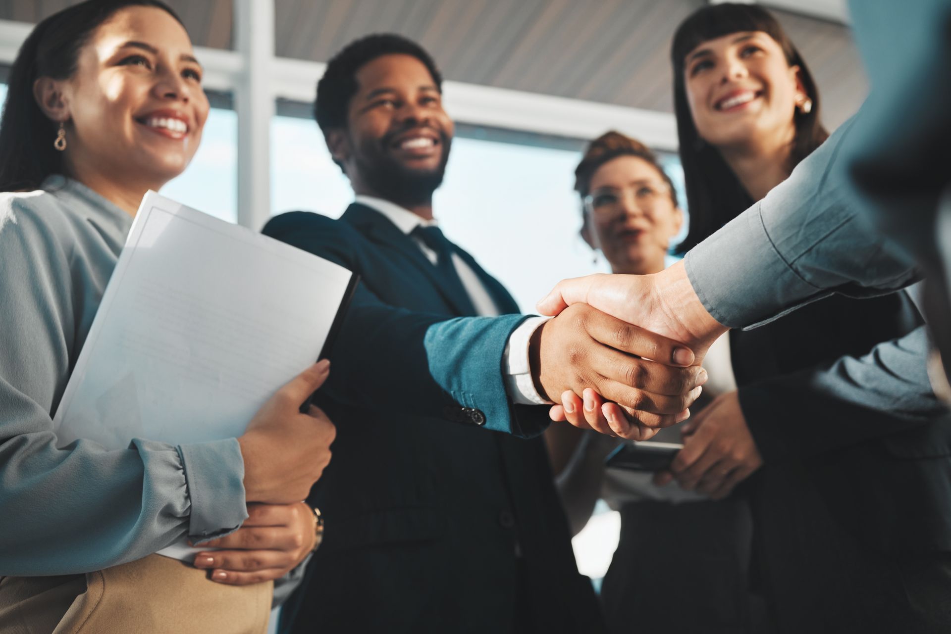 A group of Notaries are shaking hands at a Networking event.