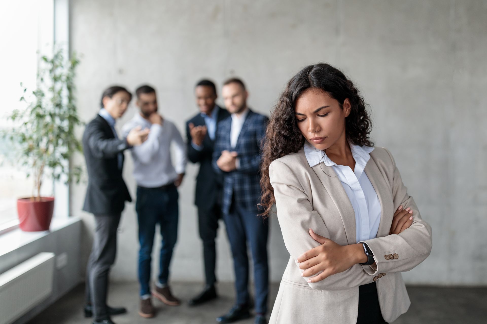 A woman is standing in front of a group of businessmen.