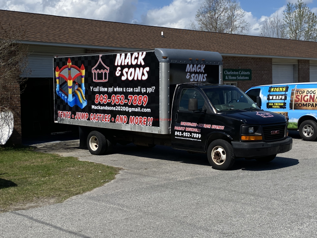 Mack & Sons moving truck parked outside a building on a sunny day