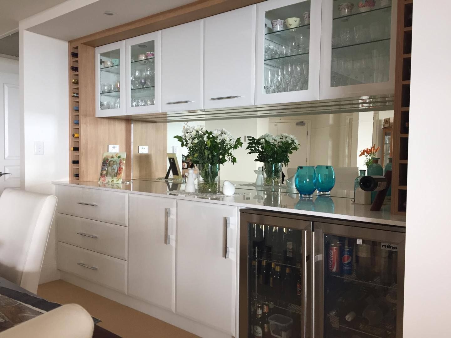 White Kitchen Cabinetry With Mirrored Backsplash, Glass-fronted Cabinets — Payton Kitchens in Highfields, QLD