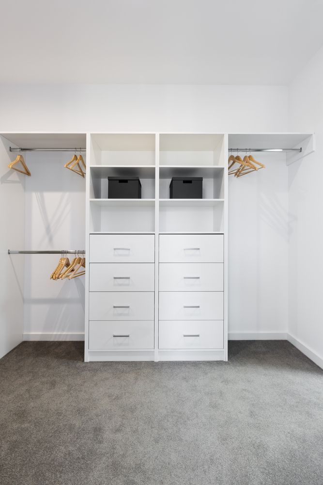 White Closet Organizer With Drawers, Shelves, and Hanging Rods; Gray Carpet, Empty Space — Payton Kitchens in St George, QLD