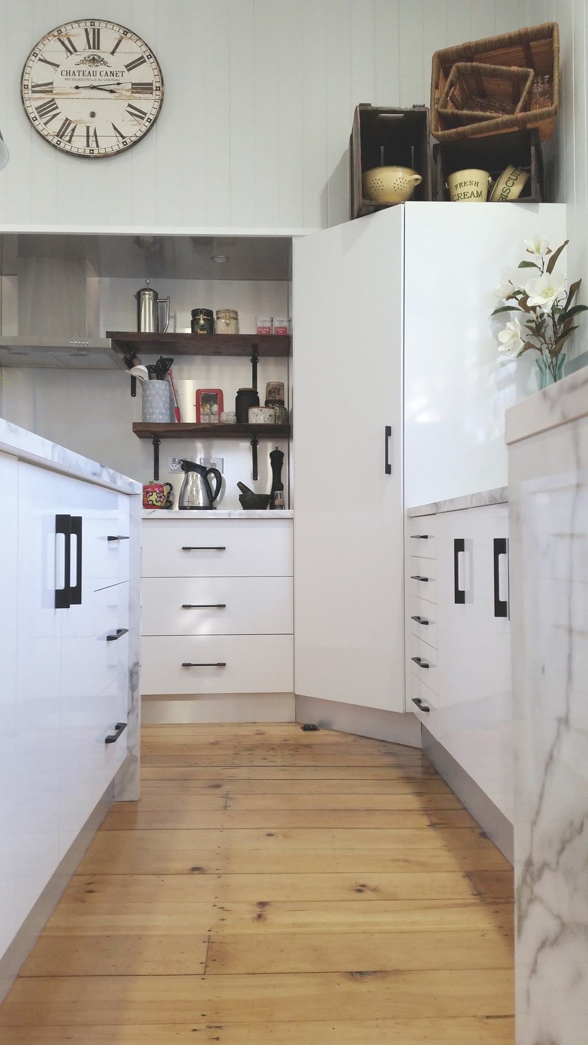 White Kitchen With Wood Floor and Marble Countertops — Payton Kitchens in Crows Nest, QLD