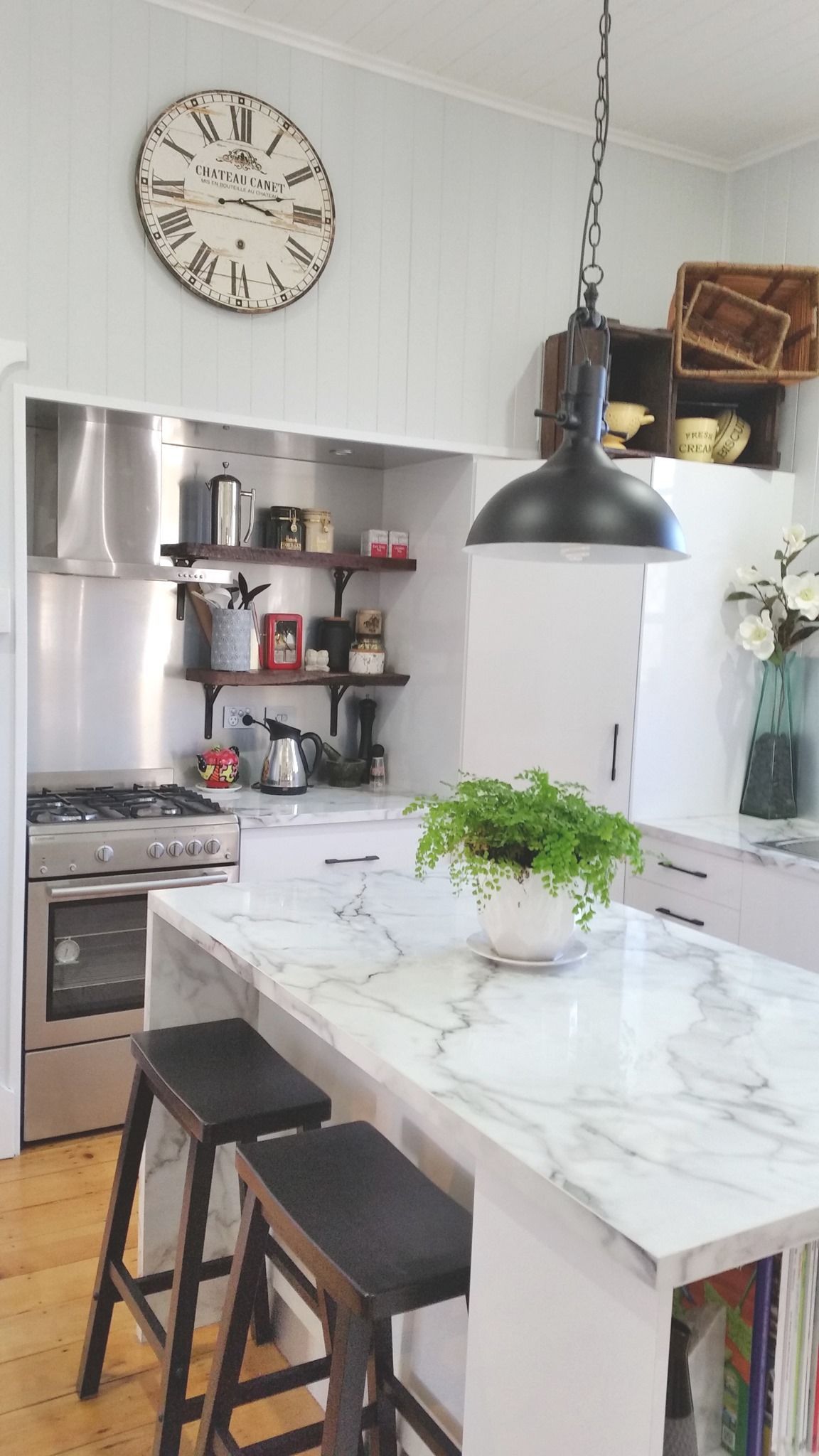 Kitchen With Marble Countertop Island, Stove, Shelves, and Clock — Payton Kitchens in Oakey, QLD