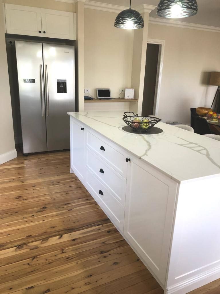 White Kitchen Island With Quartz Countertop and Hardwood Floors — Payton Kitchens in Goodiwindi, QLD
