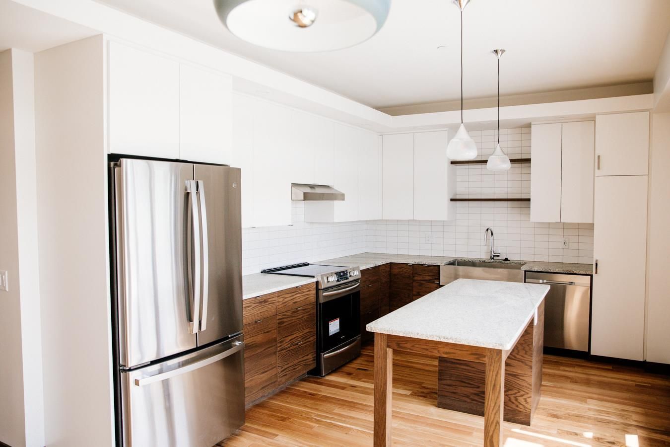 A kitchen with stainless steel appliances and wooden cabinets