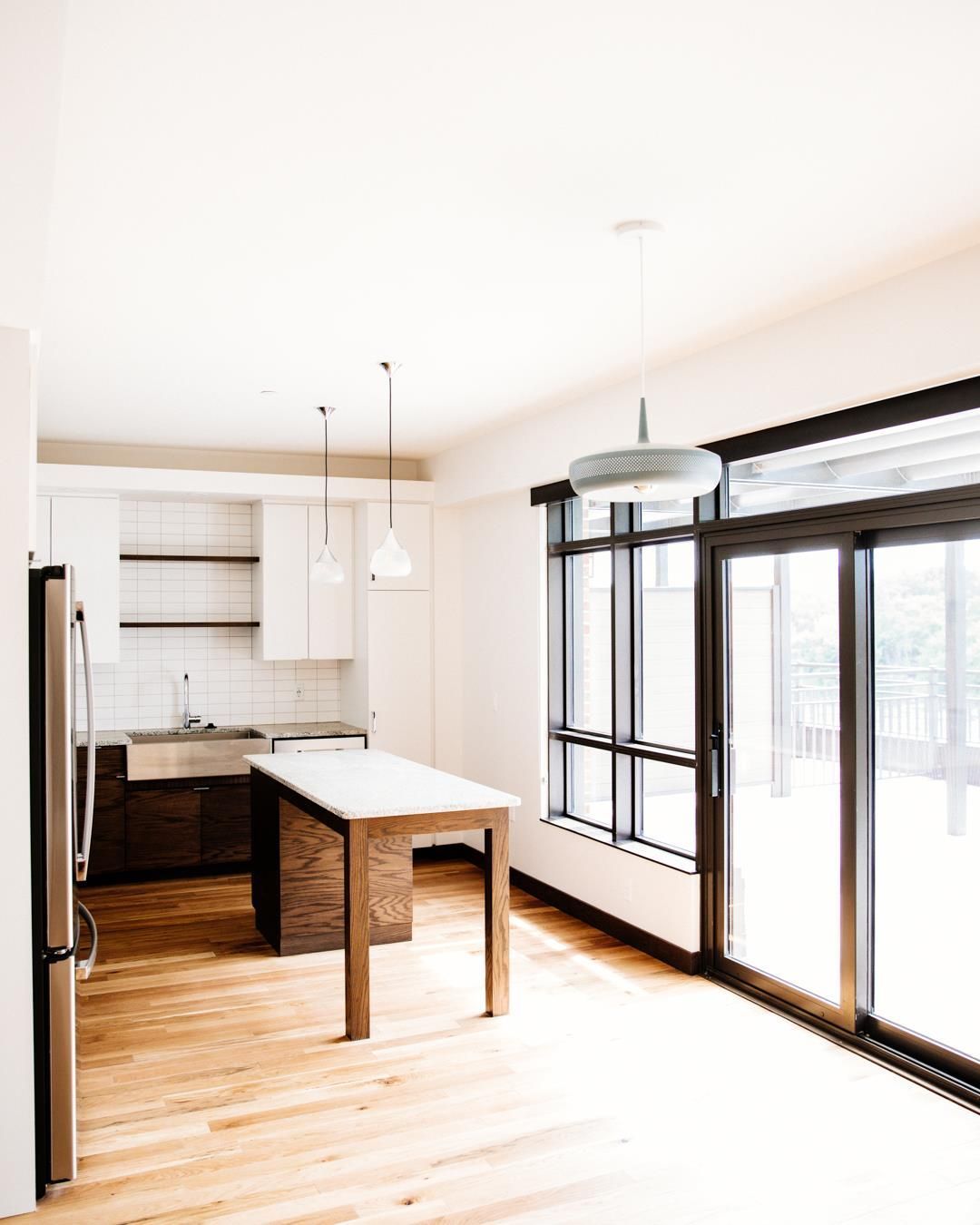 A kitchen with a table and sliding glass doors