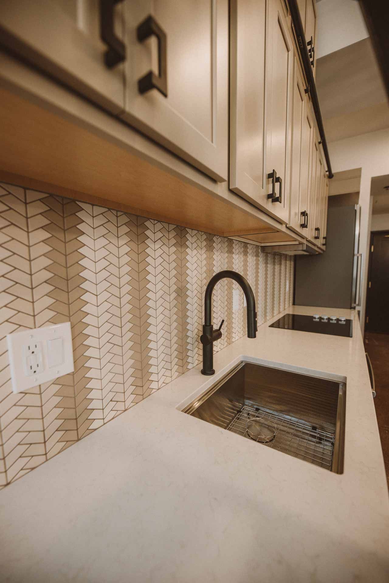 A kitchen with a sink and a faucet on the counter.
