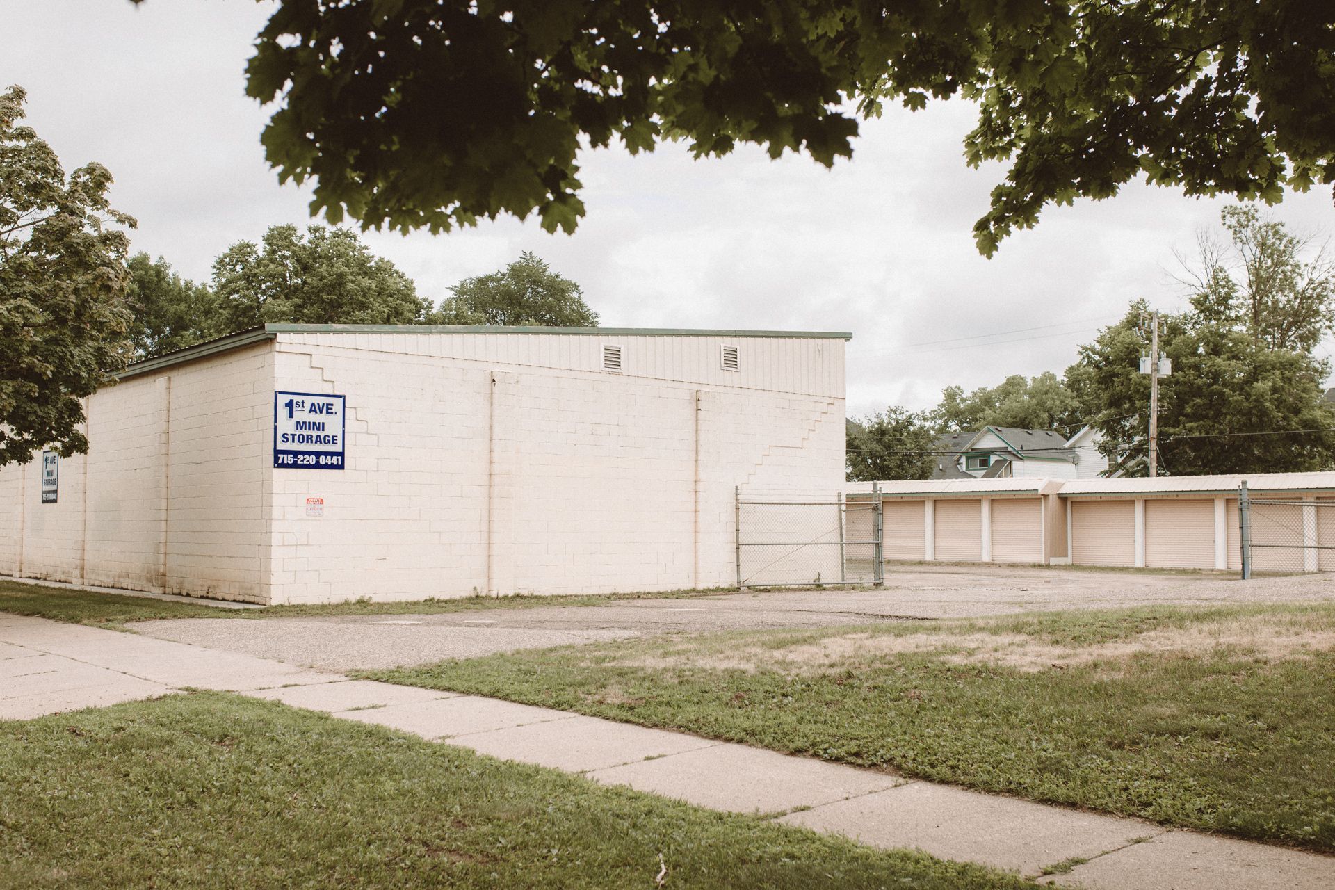 A white building with a blue sign on the side that says 