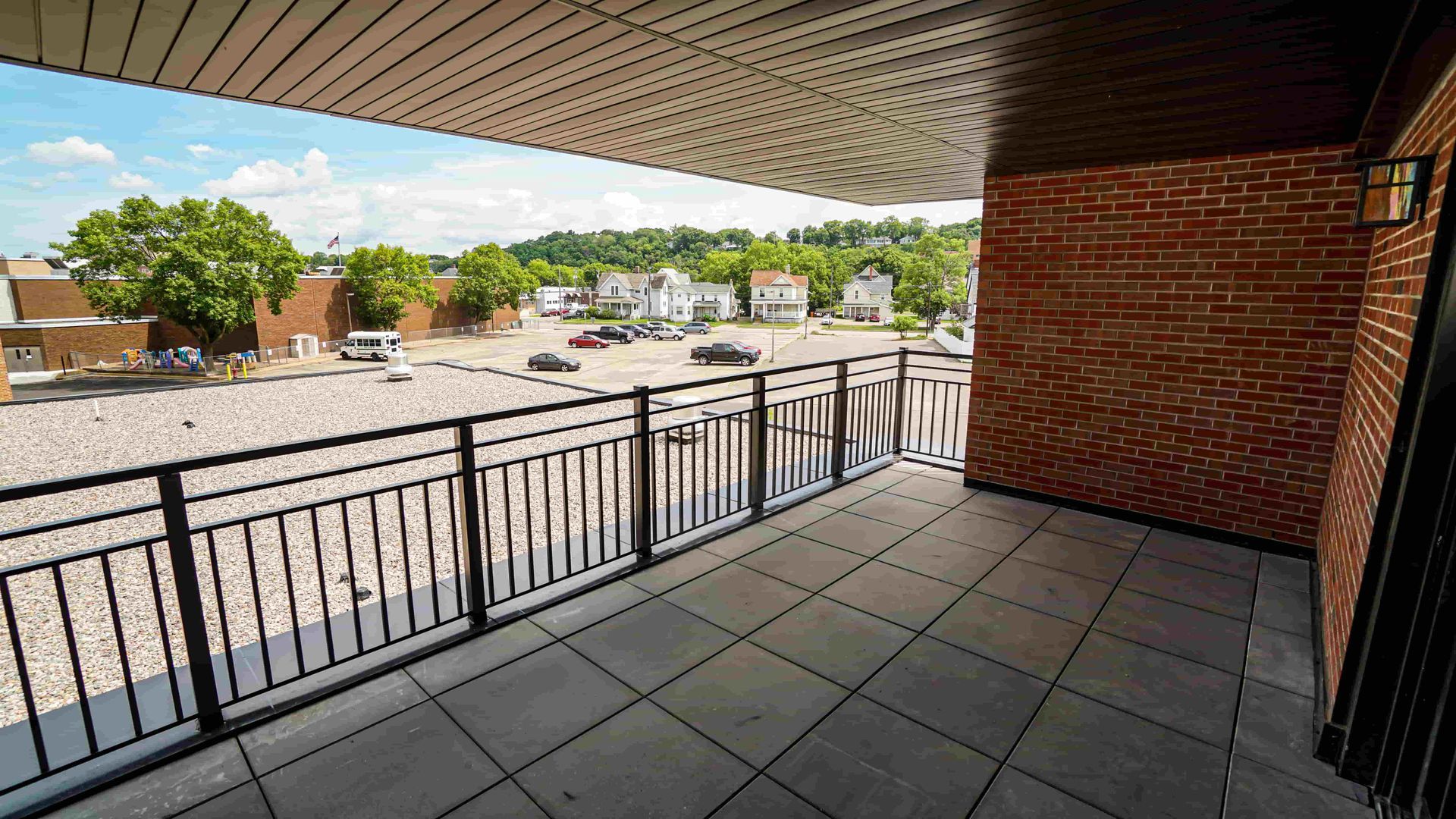 A balcony with a railing and a view of a city.