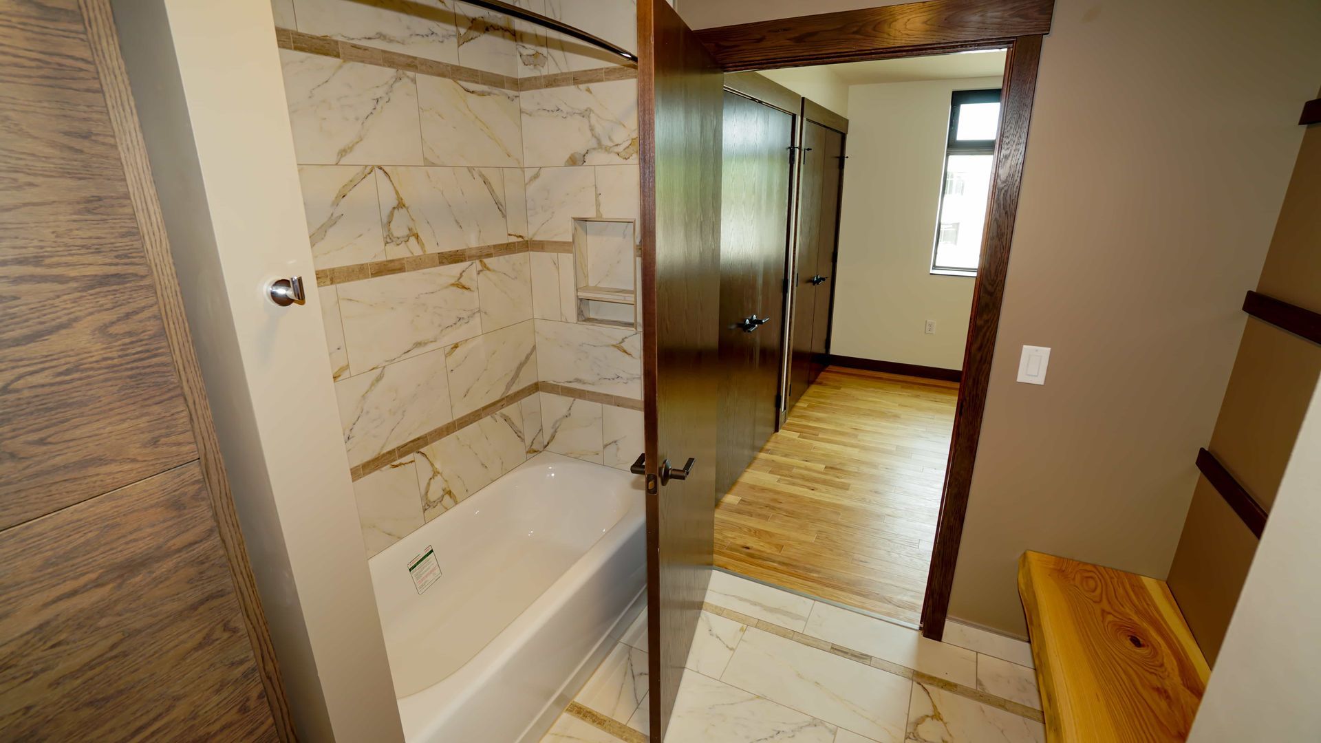 A bathroom with a tub , sink , and shower.