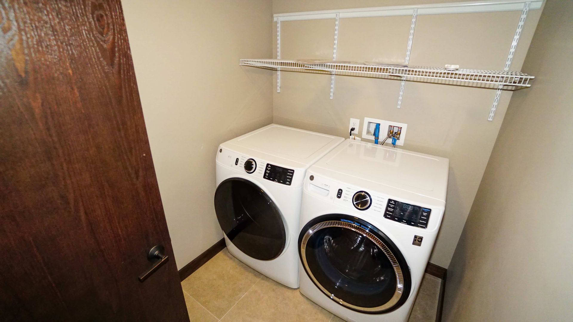 A laundry room with a washer and dryer in it.