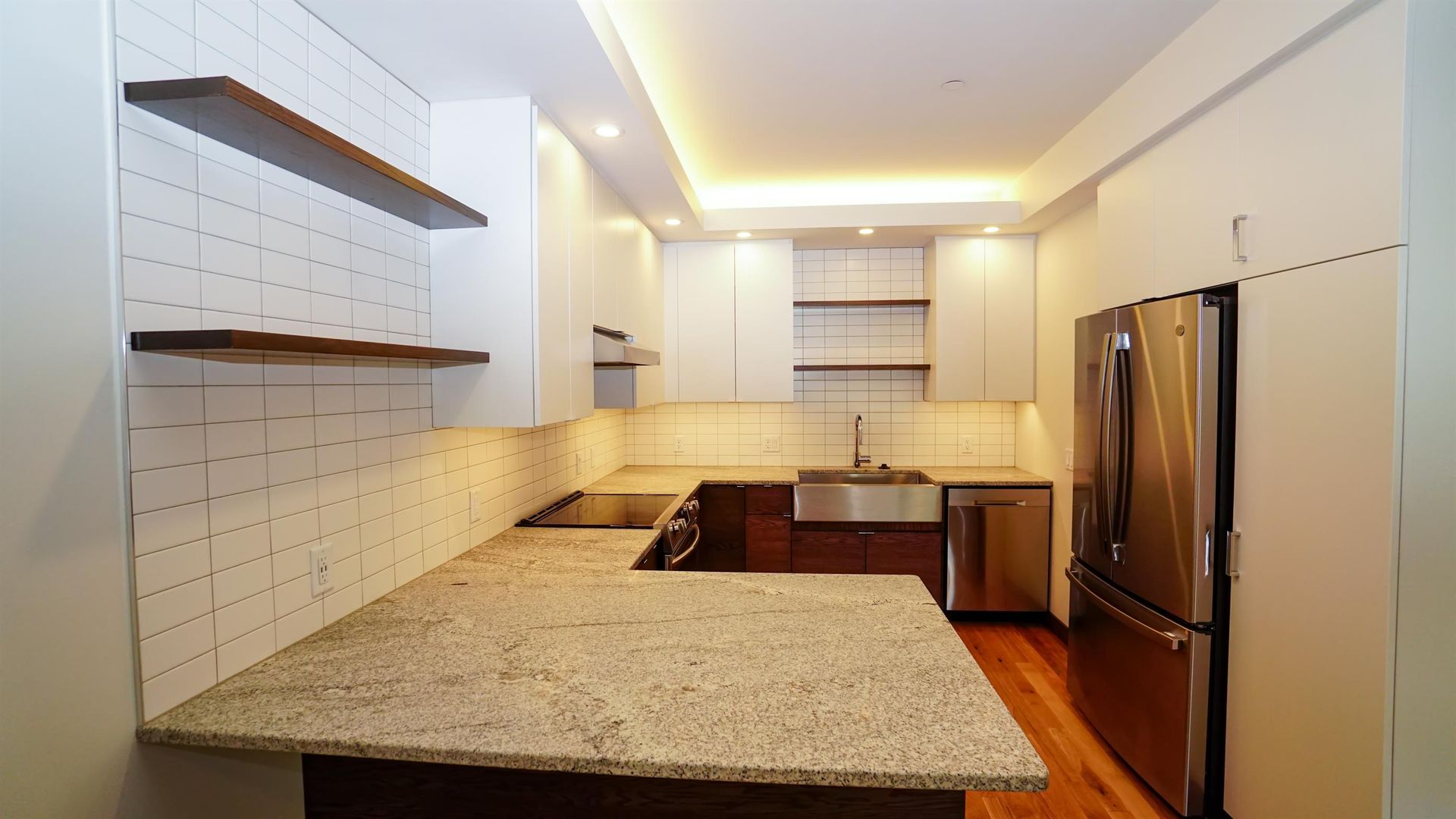 A kitchen with granite counter tops and stainless steel appliances