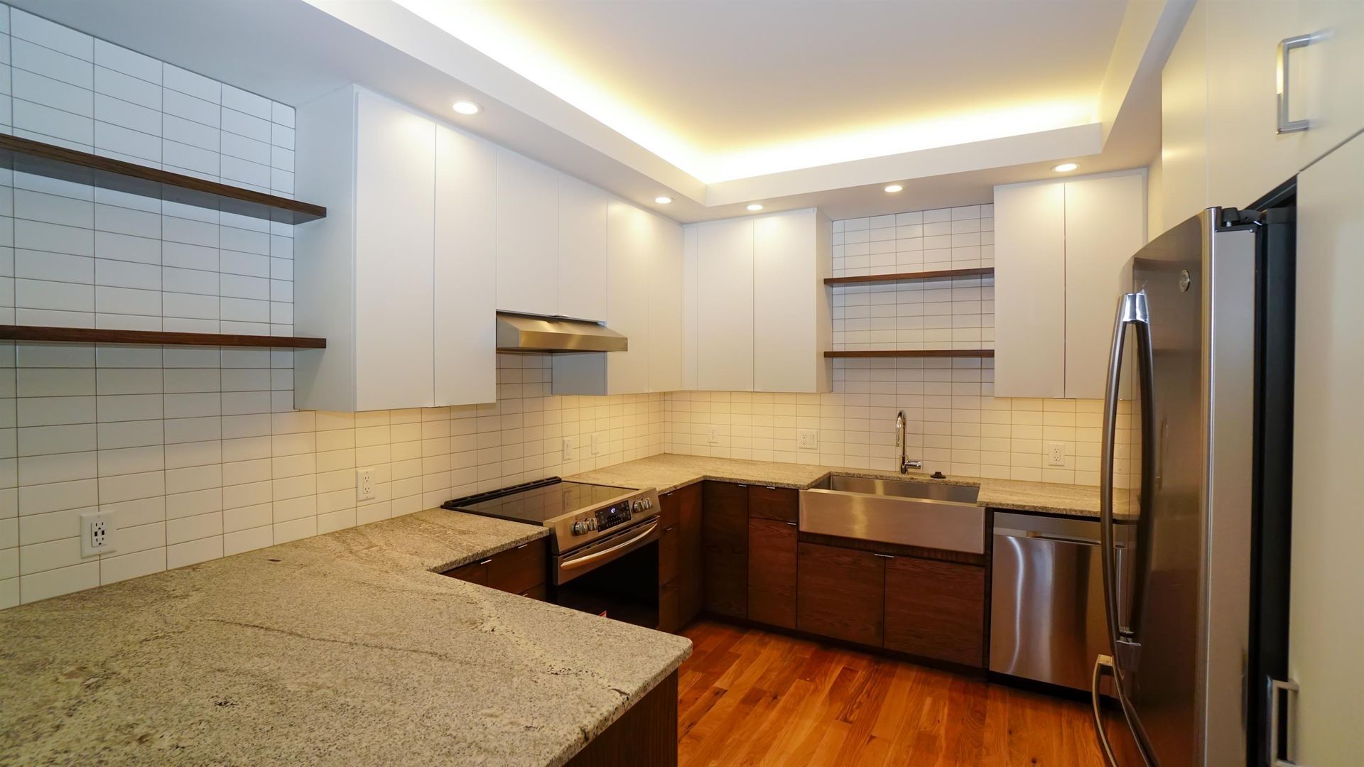 A kitchen with granite counter tops and stainless steel appliances