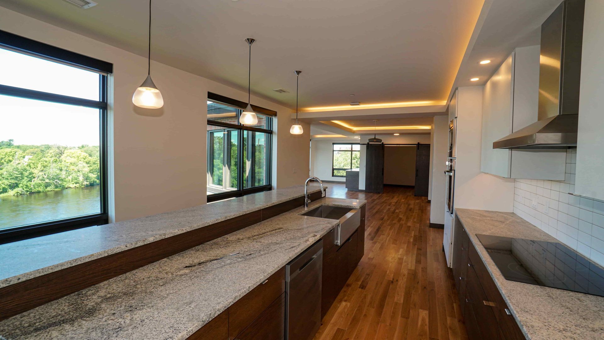 A kitchen with granite counter tops and stainless steel appliances