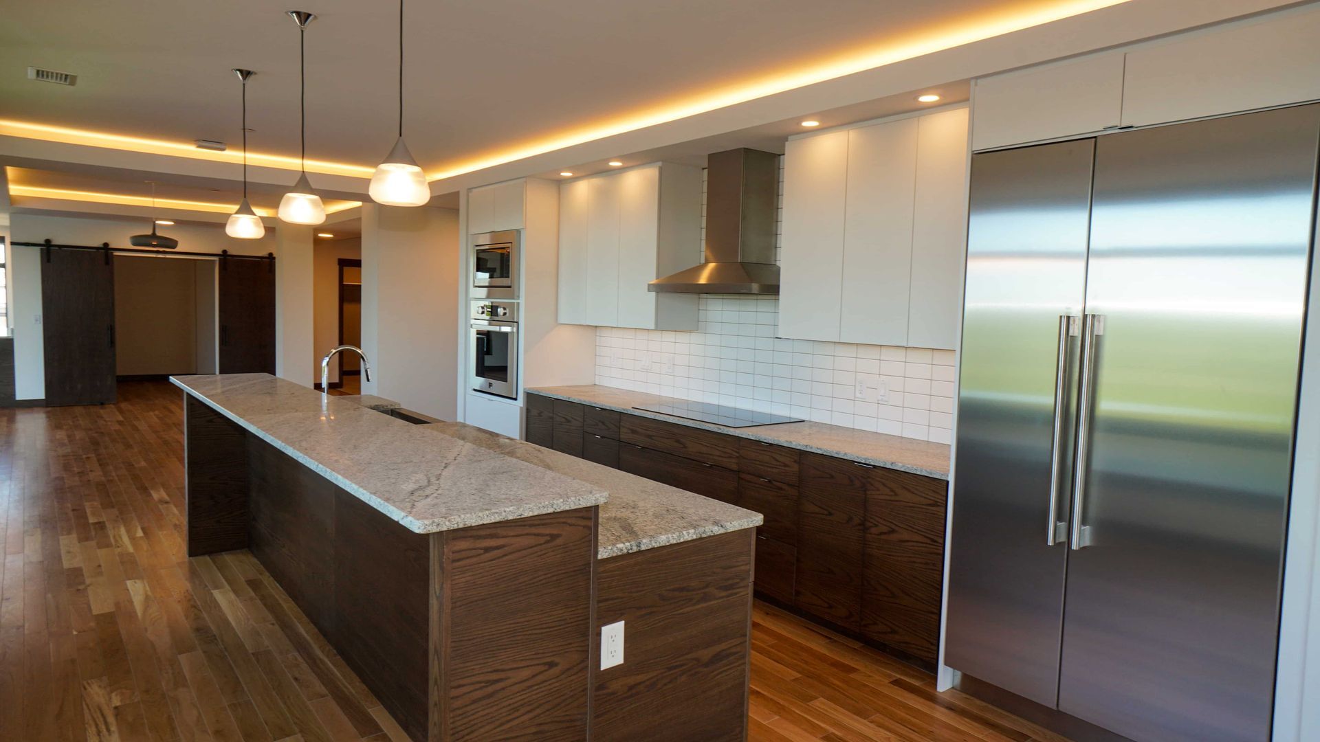A kitchen with stainless steel appliances and granite counter tops