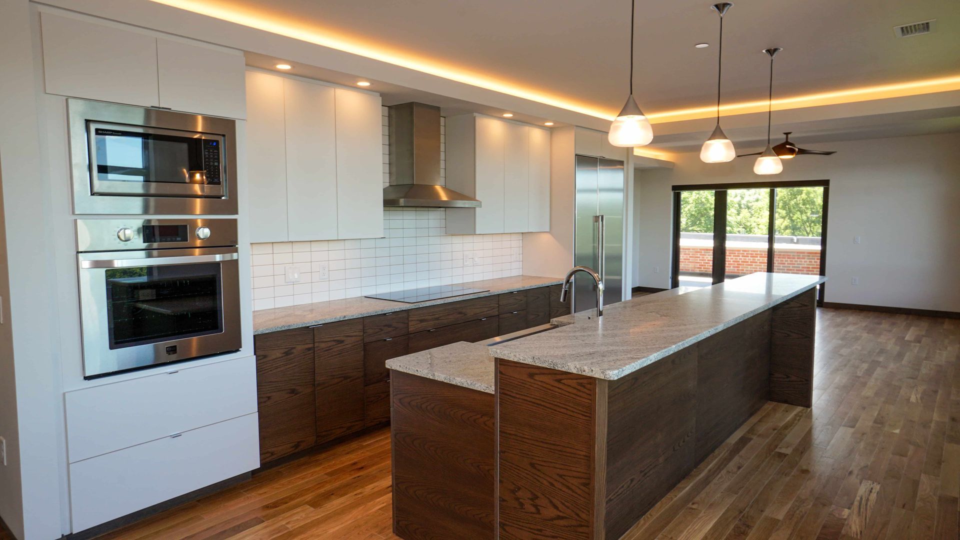 A kitchen with stainless steel appliances and a large island