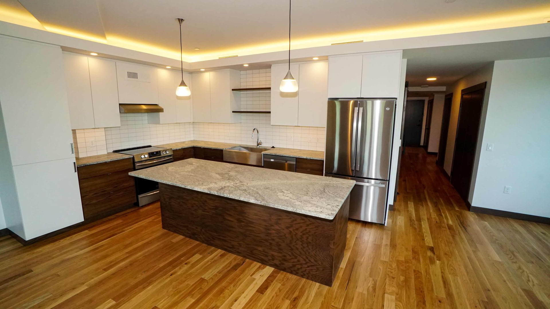 A kitchen with a large island and stainless steel appliances