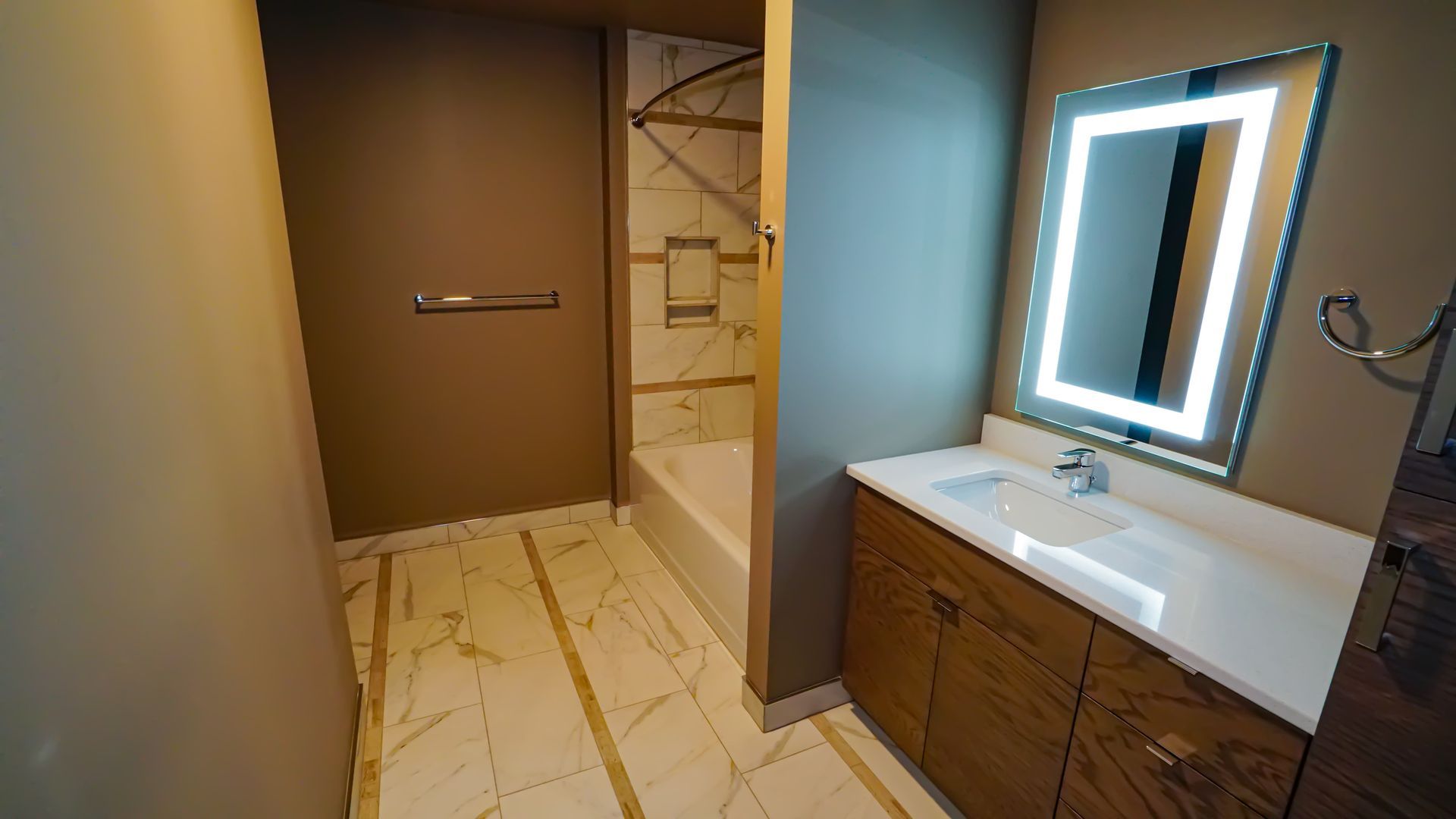 A bathroom with a sink , mirror and tub.