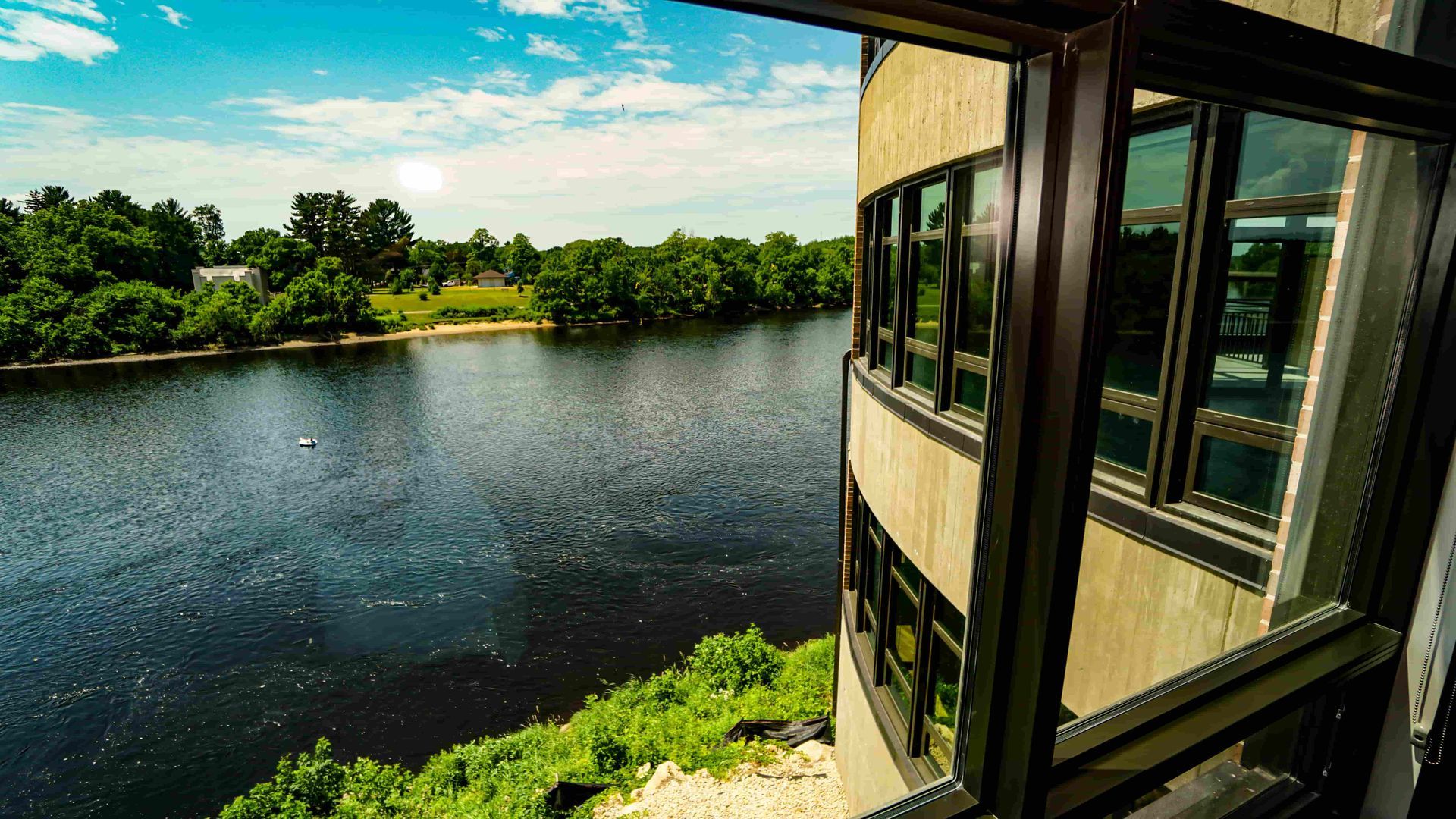 A view of a lake from a window of a building.