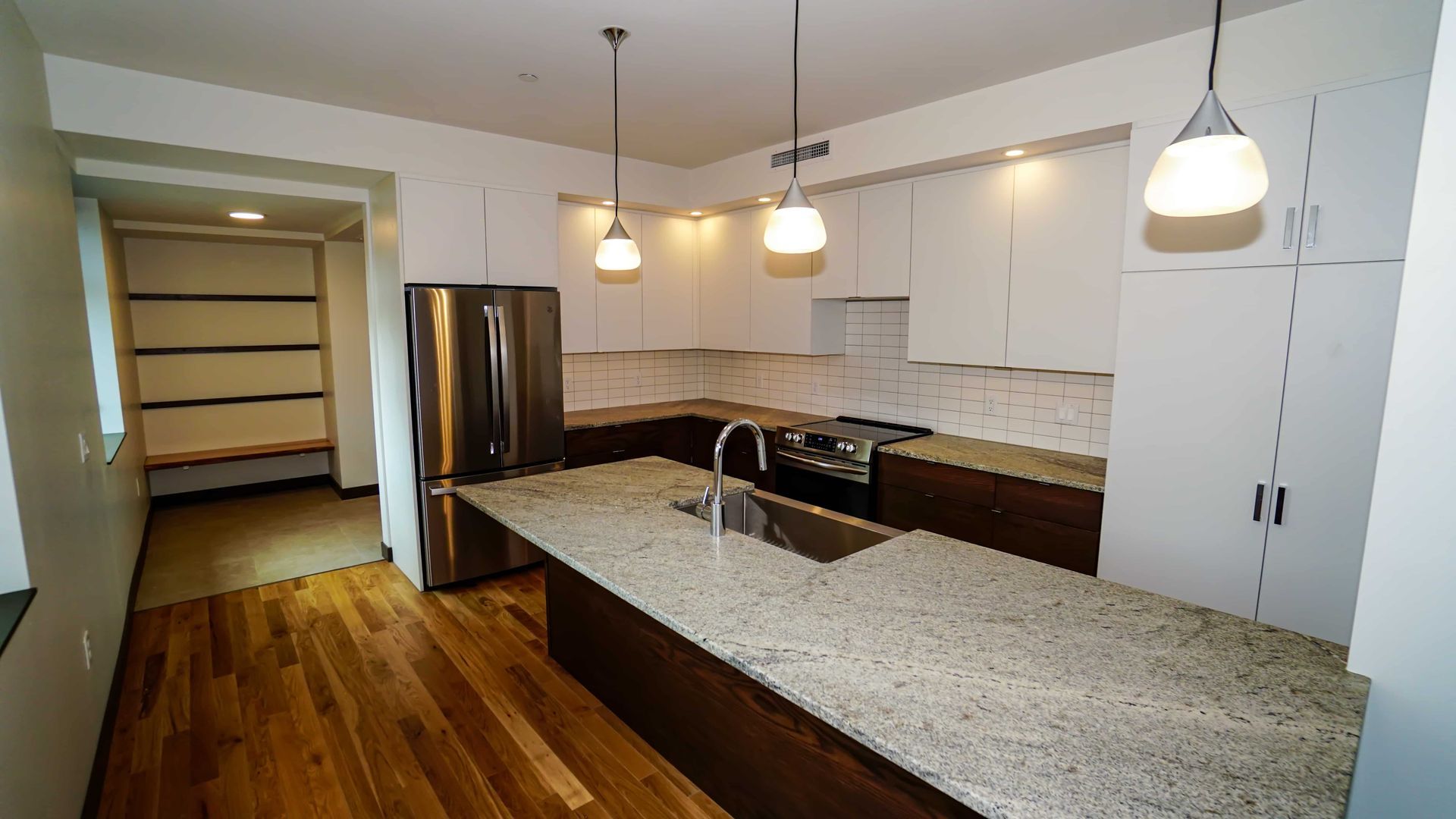 A kitchen with granite counter tops and stainless steel appliances
