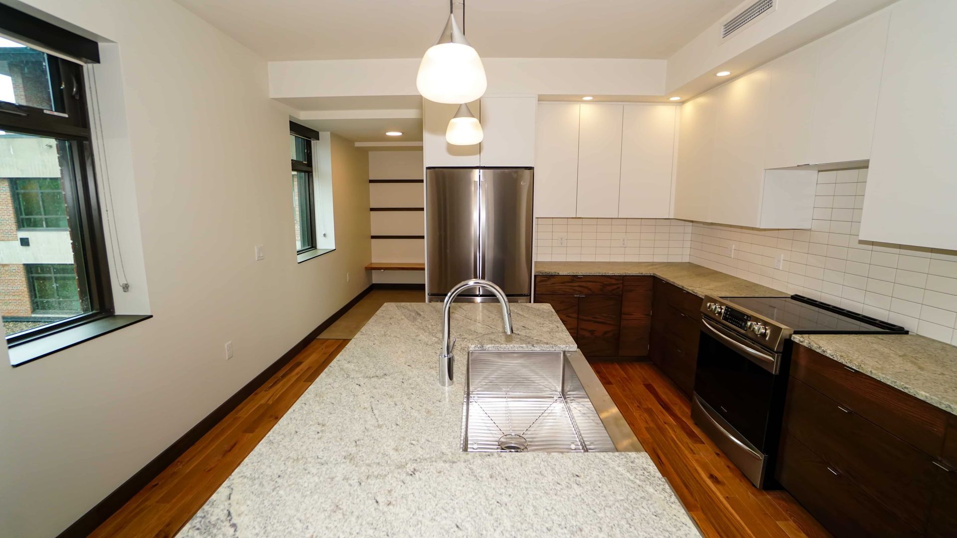 A kitchen with granite counter tops and stainless steel appliances