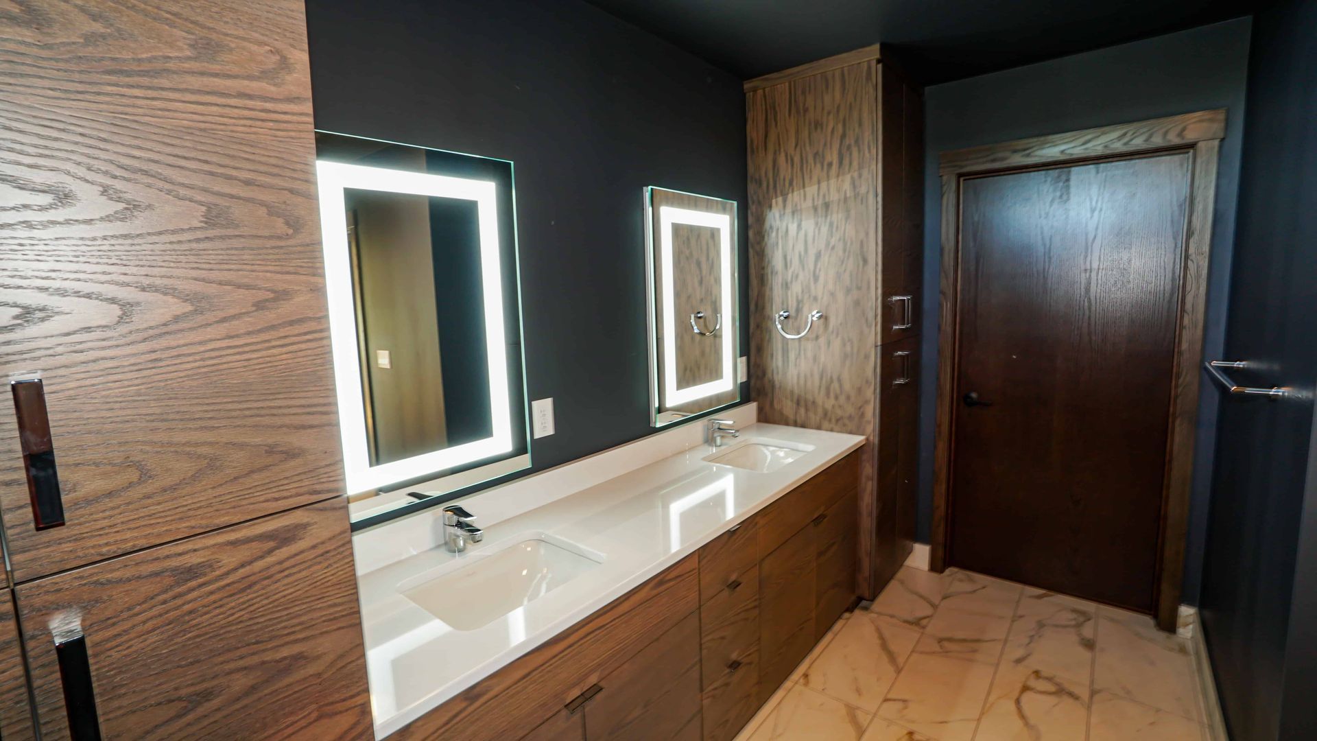 A bathroom with two sinks and two mirrors.
