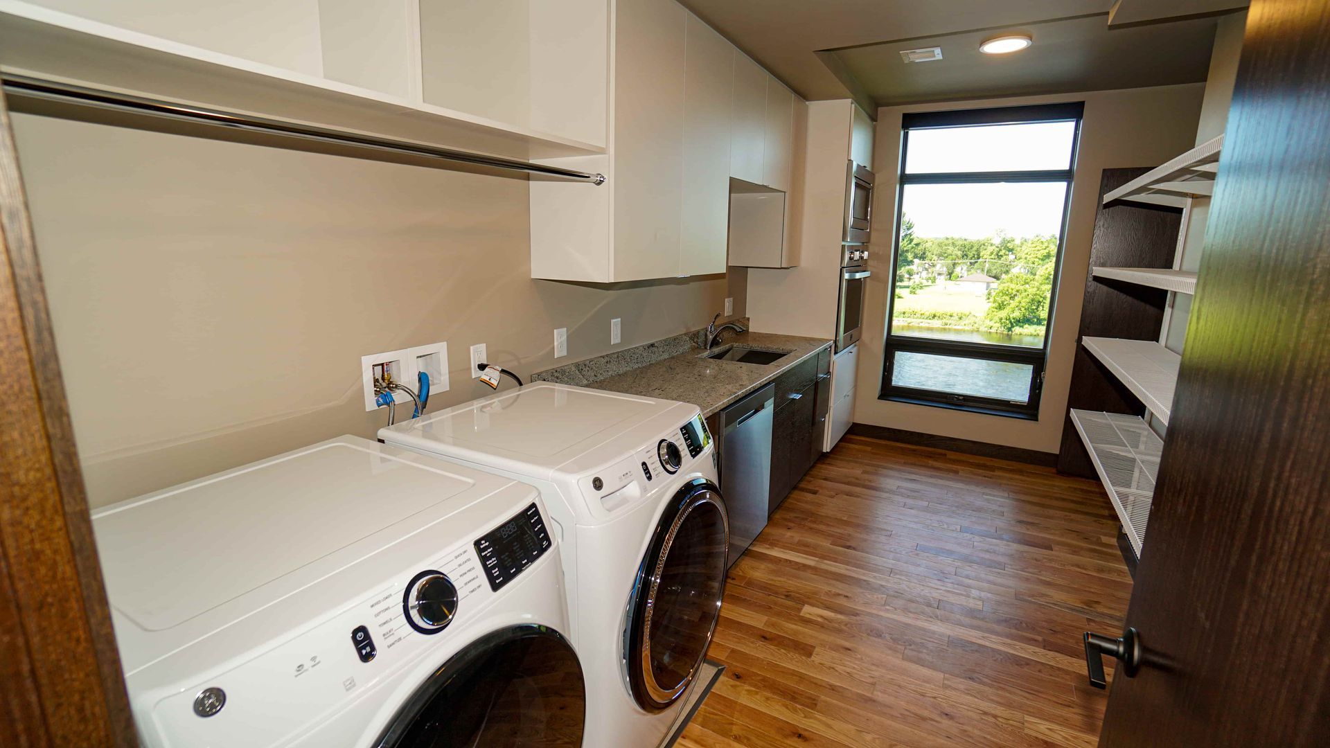 A laundry room with a washer and dryer and a window.