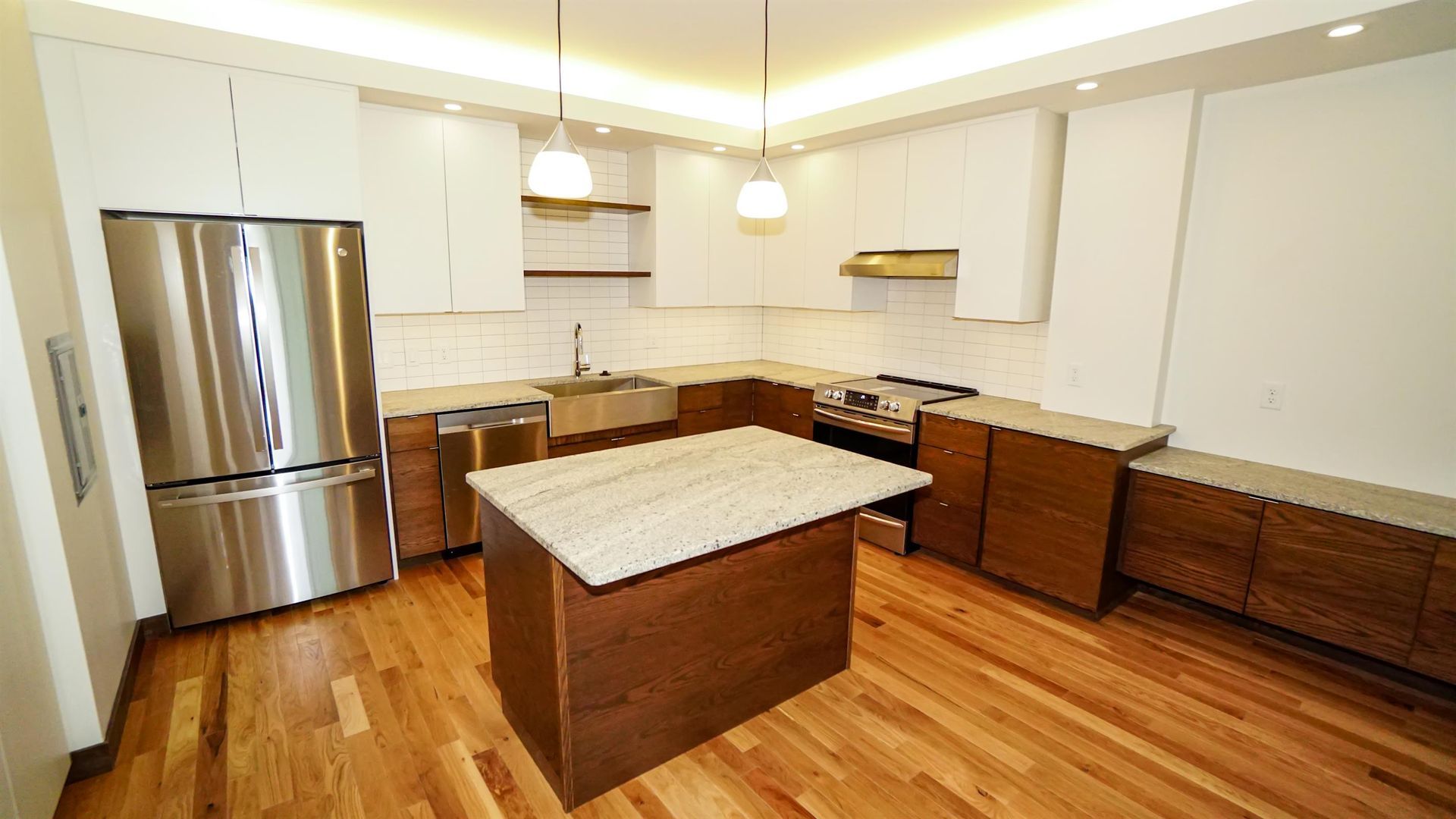 A kitchen with a large island and stainless steel appliances