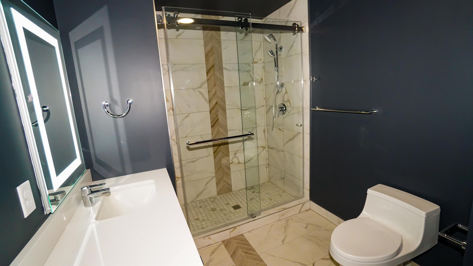 A bathroom with a toilet , sink , and shower.