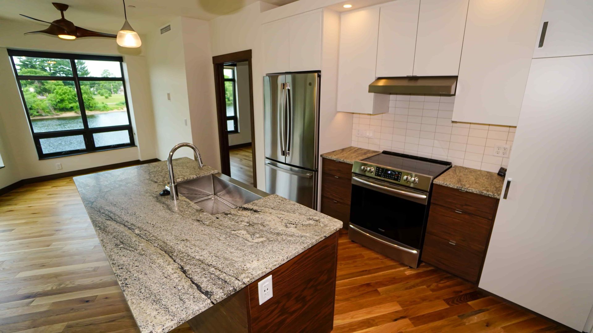 A kitchen with granite counter tops and stainless steel appliances