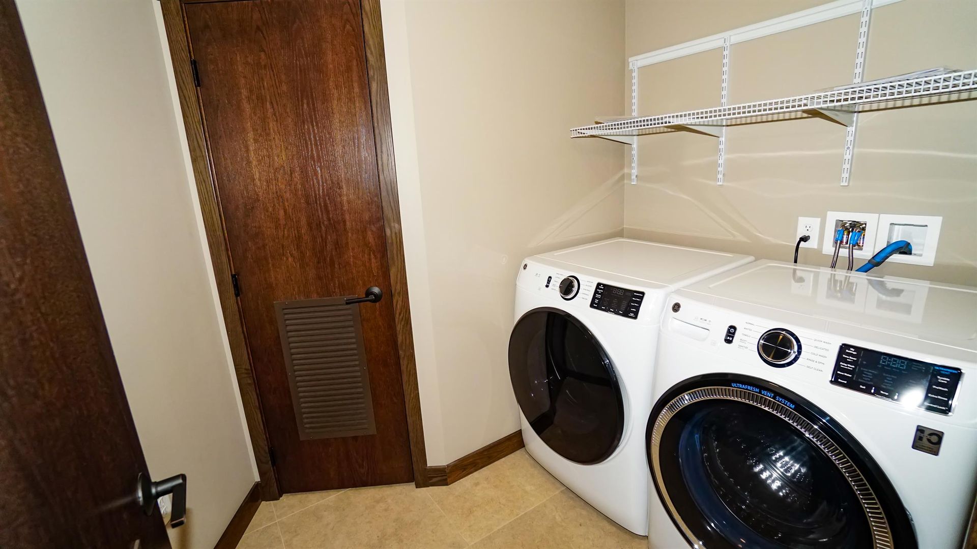 A laundry room with a washer and dryer in it.