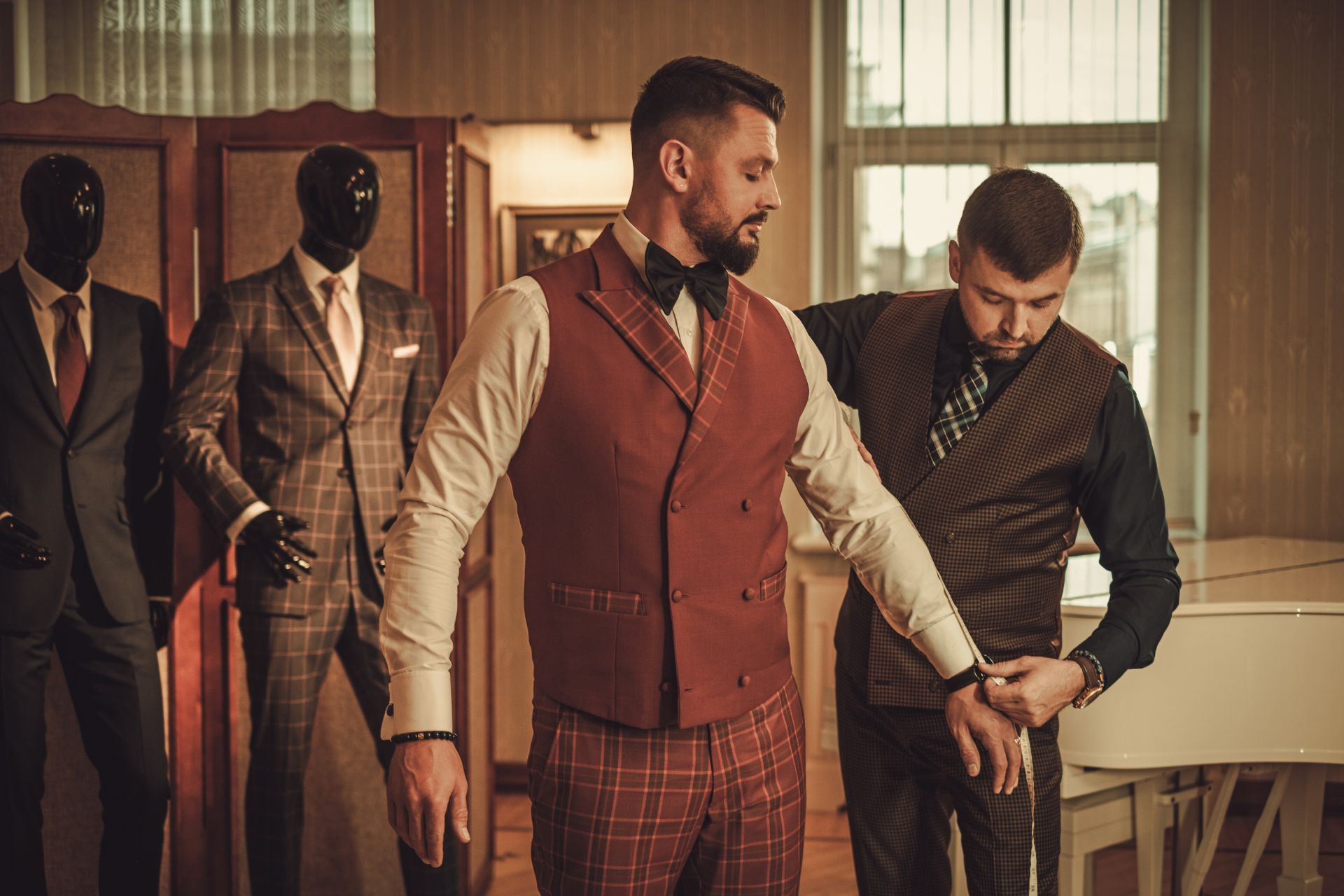 A man is getting a suit made by a tailor.