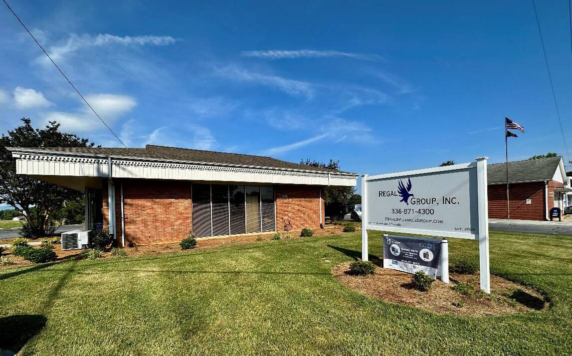 A brick building with a sign for